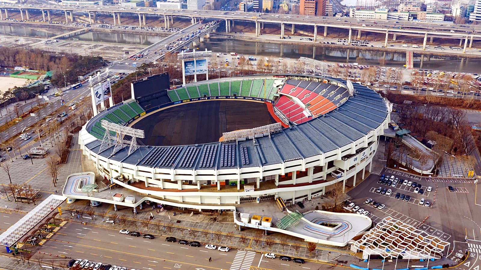 Jamsil Baseball Stadium in Seoul during a KBO League game, the stands filled under floodlights